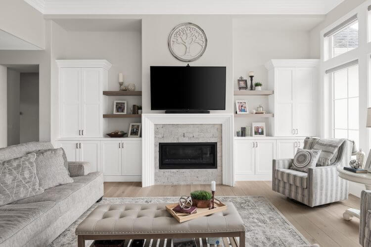 A living room with white furniture and a flat screen TV. Created by Pleasant Grove Utah Custom Home Builders