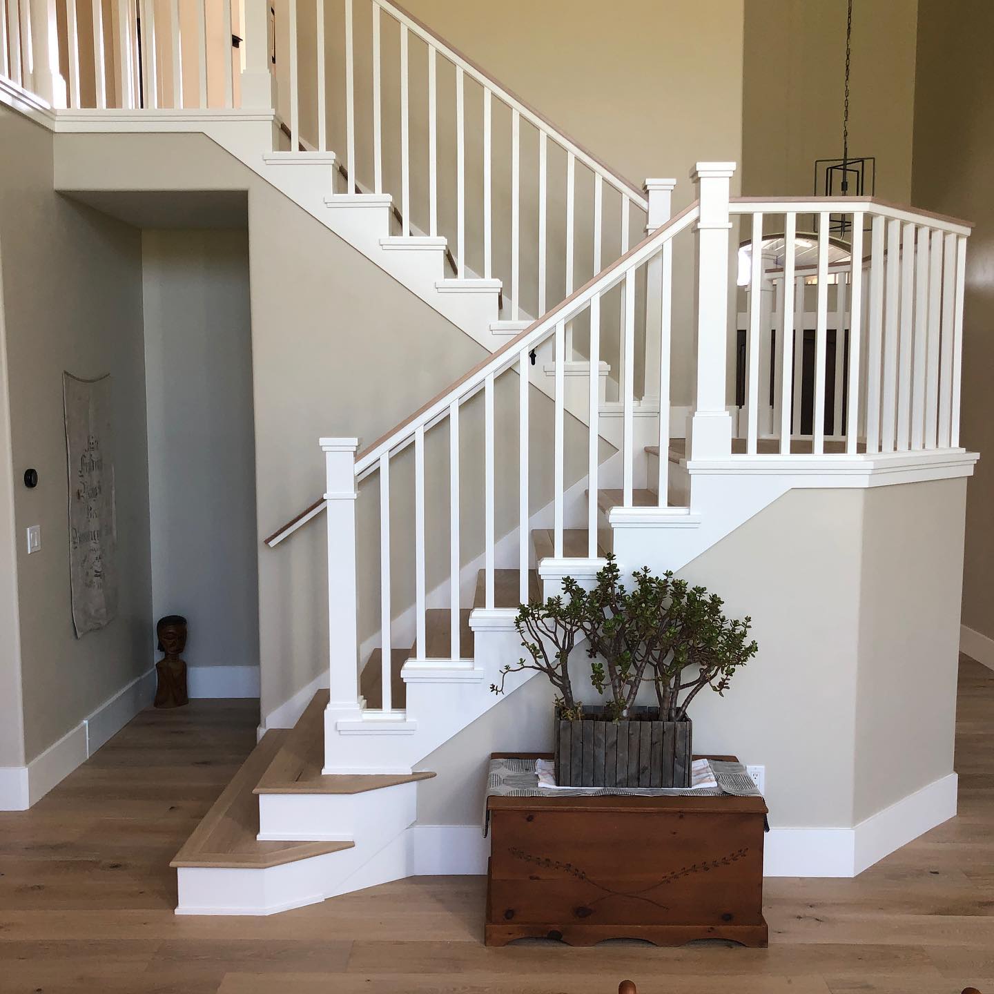A staircase with white railings and wooden floors